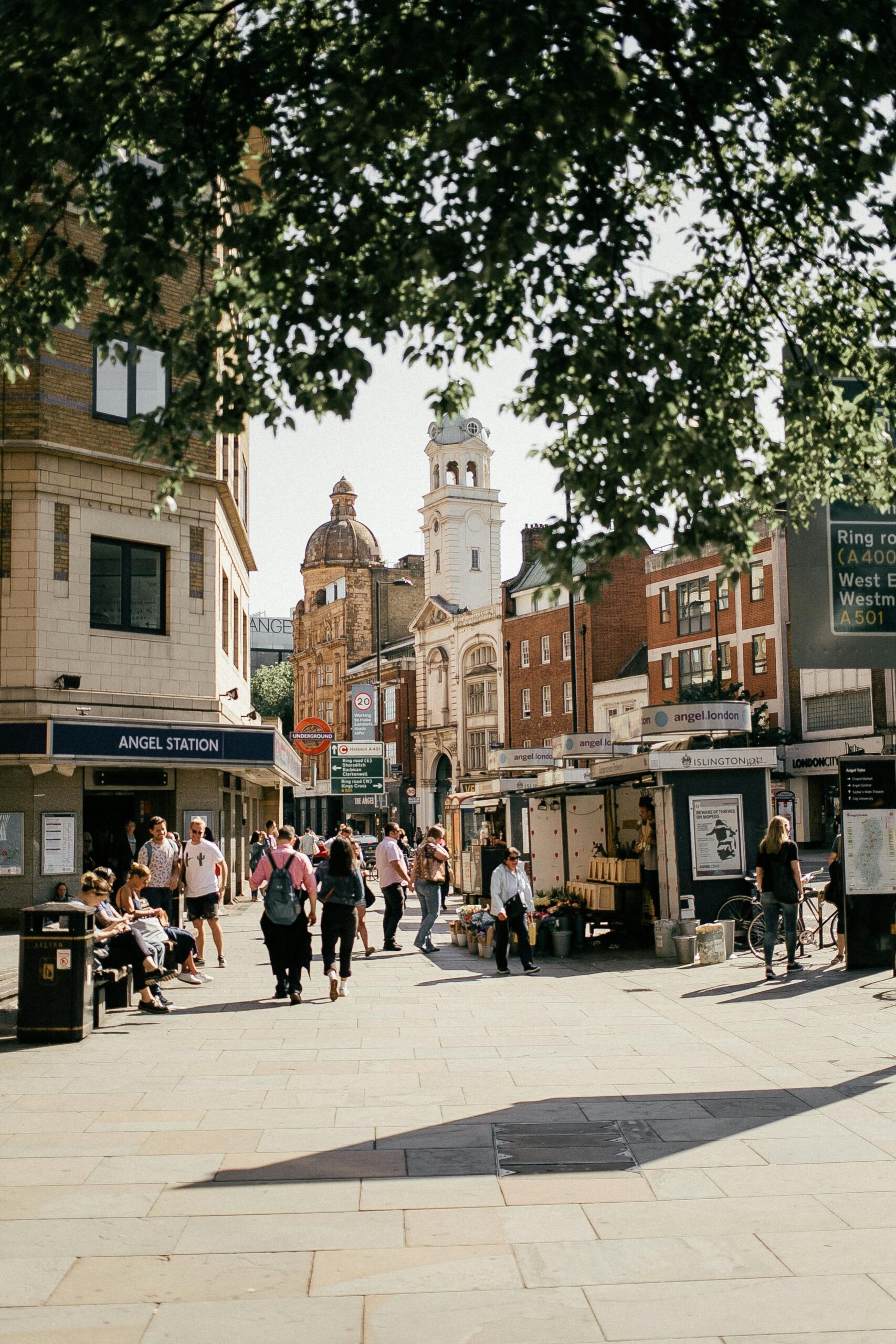 Busy urban scene outside Angel Station, London, capturing people and architecture.